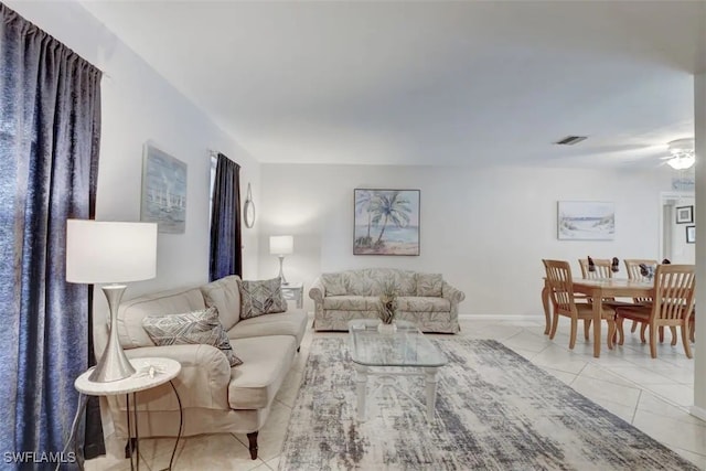 living room featuring ceiling fan and light tile patterned flooring