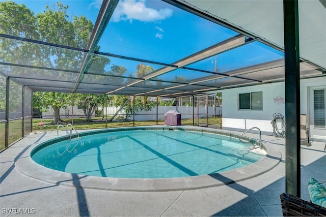 view of pool featuring a patio area and glass enclosure