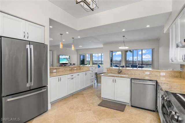 kitchen featuring kitchen peninsula, white cabinetry, sink, and stainless steel appliances