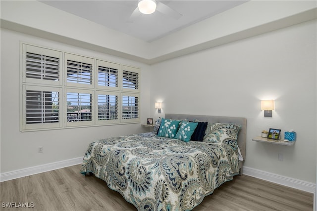 bedroom featuring hardwood / wood-style flooring and ceiling fan