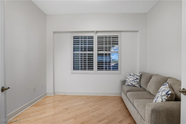 living area with hardwood / wood-style flooring