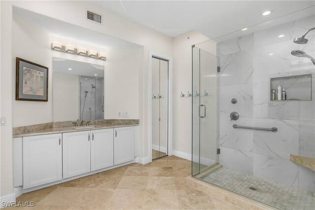 bathroom featuring vanity and a shower with shower door