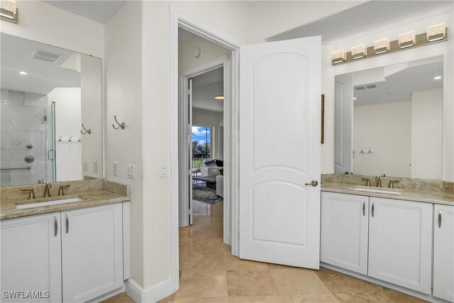 bathroom featuring vanity and a shower with shower door