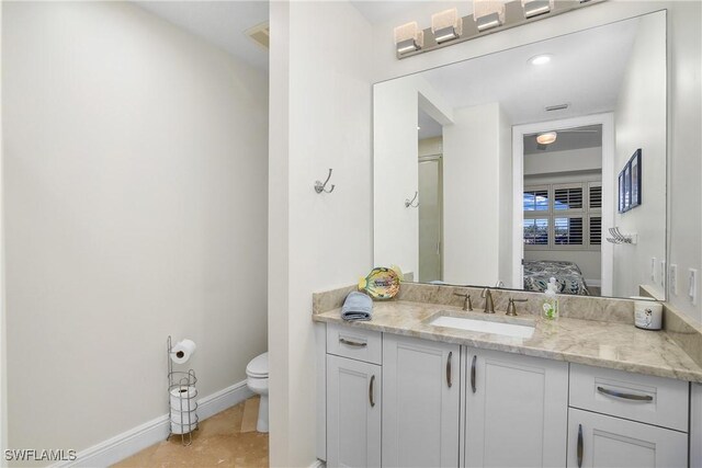 bathroom featuring vanity and toilet