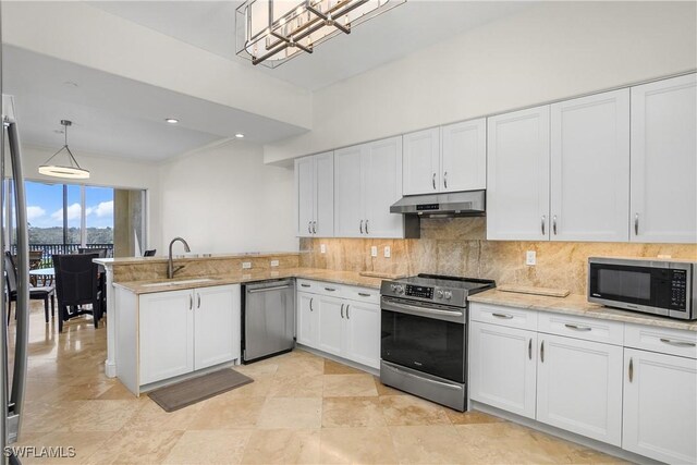 kitchen featuring sink, kitchen peninsula, decorative light fixtures, white cabinetry, and stainless steel appliances