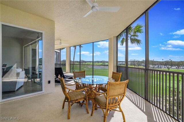 sunroom with plenty of natural light and ceiling fan