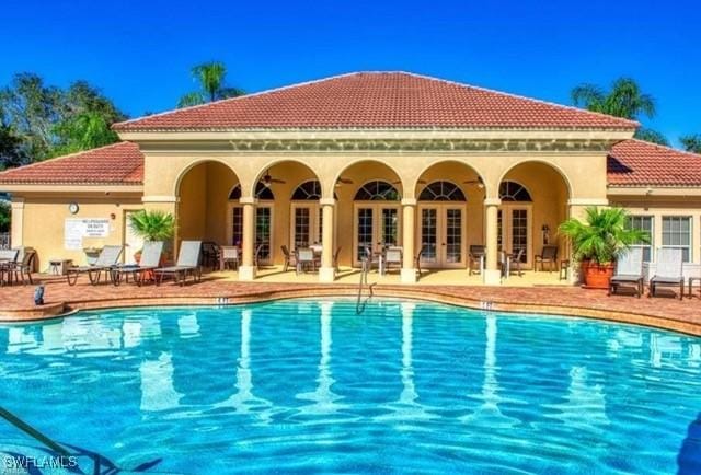 community pool featuring a ceiling fan, french doors, and a patio