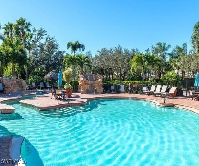 community pool featuring a patio area and fence