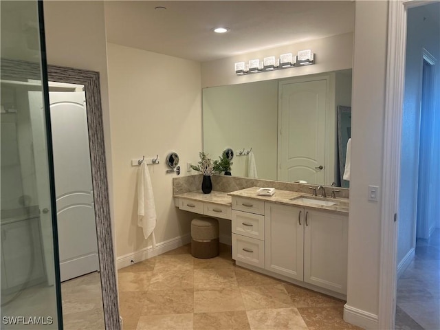 bathroom with vanity and baseboards