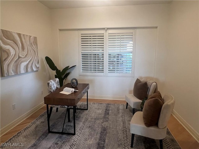 office area featuring baseboards and wood finished floors