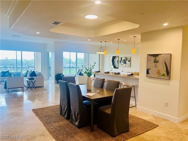 dining area featuring recessed lighting, a raised ceiling, visible vents, and baseboards