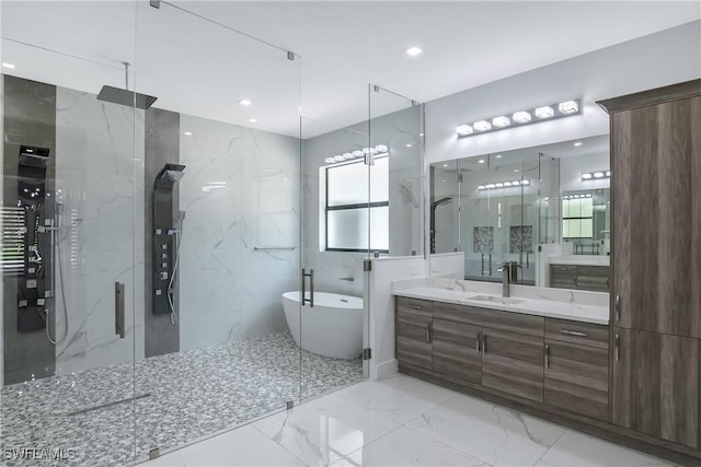 bathroom with shower with separate bathtub, vanity, and tile walls