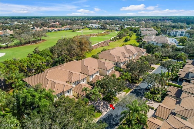 birds eye view of property featuring view of golf course and a residential view