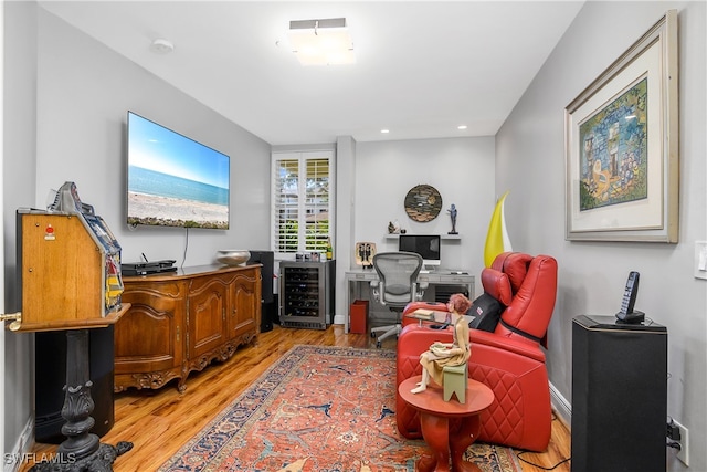 office space featuring wine cooler, light wood-style flooring, and recessed lighting