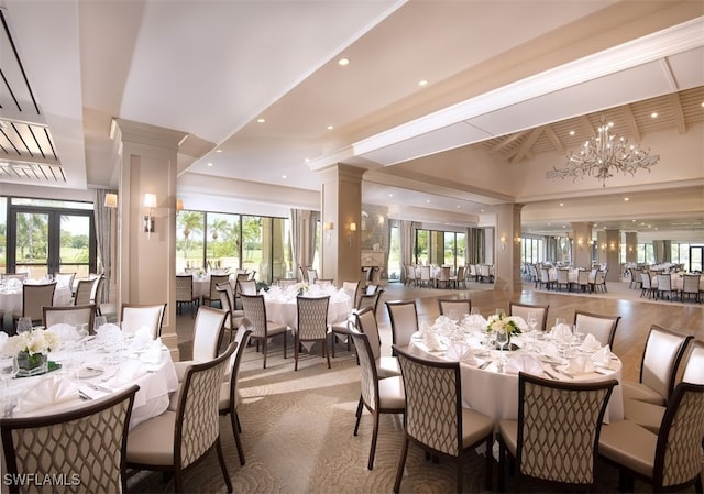 dining room featuring a chandelier, recessed lighting, french doors, and decorative columns