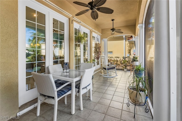 sunroom with ornate columns and ceiling fan