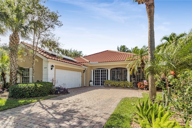 mediterranean / spanish-style home with a garage