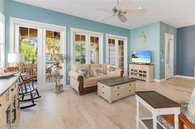 living room featuring light hardwood / wood-style floors and ceiling fan