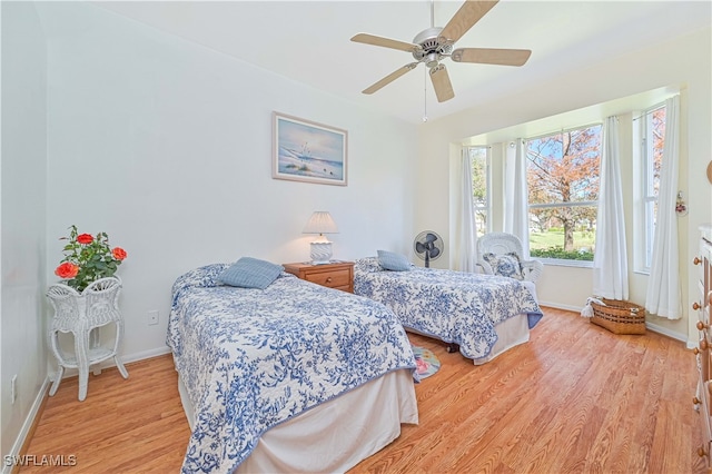 bedroom with light hardwood / wood-style flooring and ceiling fan