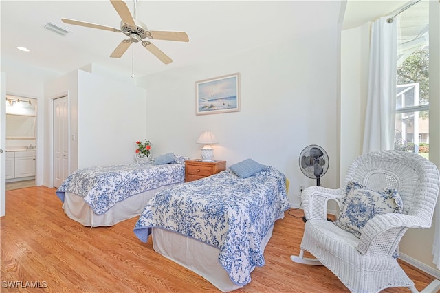 bedroom with multiple windows, light wood-type flooring, and ceiling fan