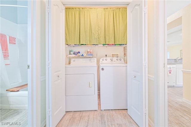 washroom featuring independent washer and dryer and light wood-type flooring