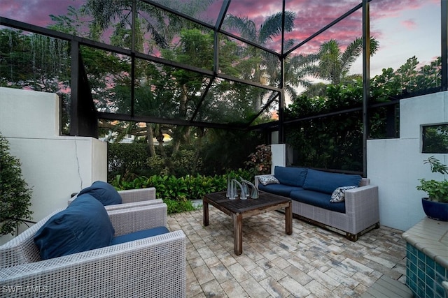 patio terrace at dusk with glass enclosure and outdoor lounge area