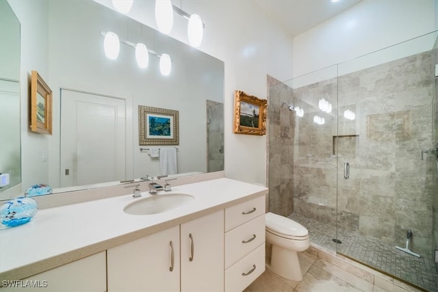 bathroom featuring vanity, walk in shower, and toilet