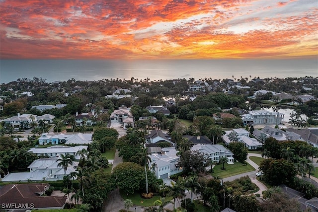 aerial view at dusk with a water view