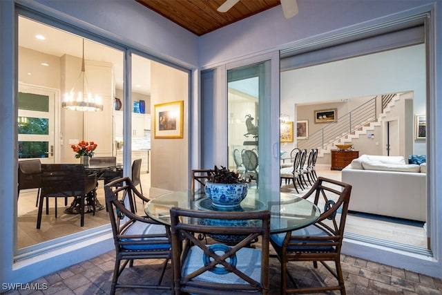 dining area featuring a chandelier and wooden ceiling