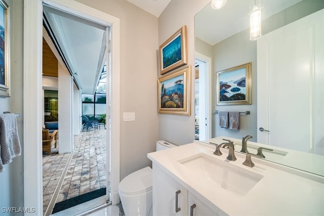 bathroom featuring toilet and vanity