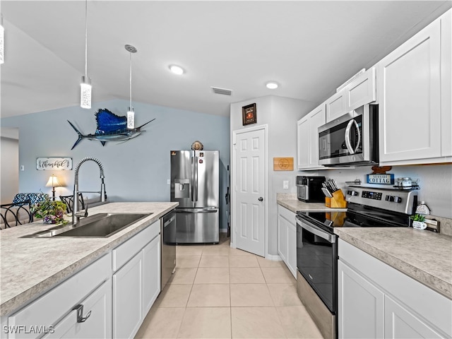 kitchen featuring sink, hanging light fixtures, light tile patterned floors, stainless steel appliances, and white cabinets