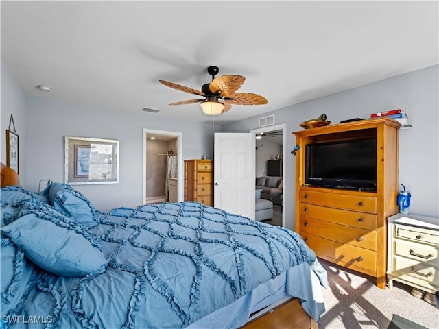 bedroom with ensuite bath and ceiling fan