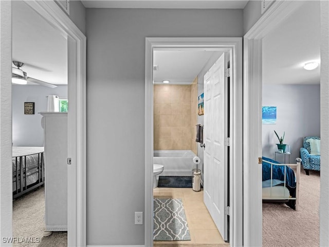 hall featuring light tile patterned flooring