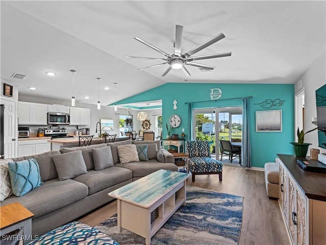 917 NW 13th Ave, Cape Coral, FL 33993 - living area featuring vaulted ceiling, ceiling fan, a wealth of natural light, and visible vents
