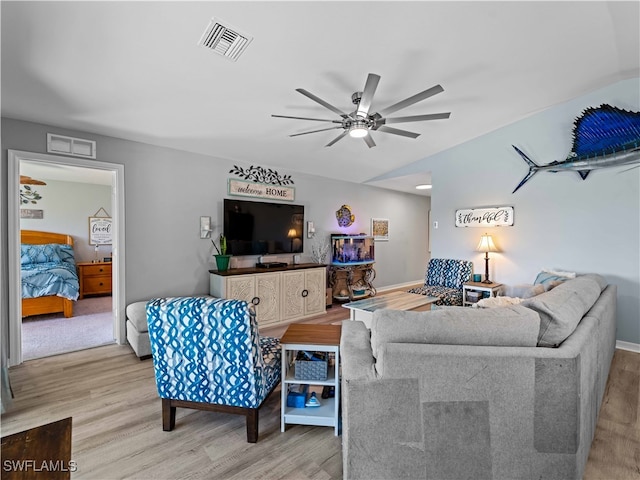 living room with ceiling fan and light wood-type flooring