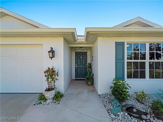 917 NW 13th Ave, Cape Coral, FL 33993 - view of exterior entry with an attached garage and stucco siding
