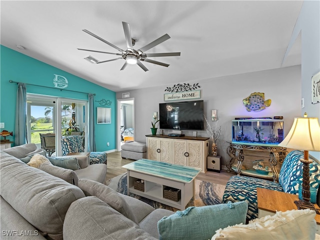 living room with vaulted ceiling, ceiling fan, and light wood-type flooring