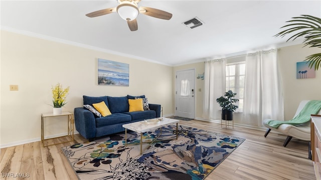 living room featuring crown molding, light wood-type flooring, and ceiling fan