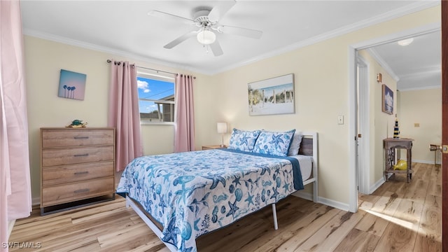 bedroom featuring crown molding, light hardwood / wood-style flooring, and ceiling fan