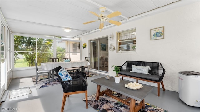 sunroom / solarium featuring ceiling fan