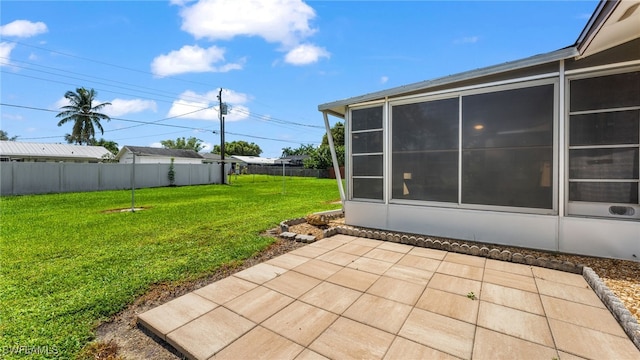 view of yard with a sunroom and a patio area