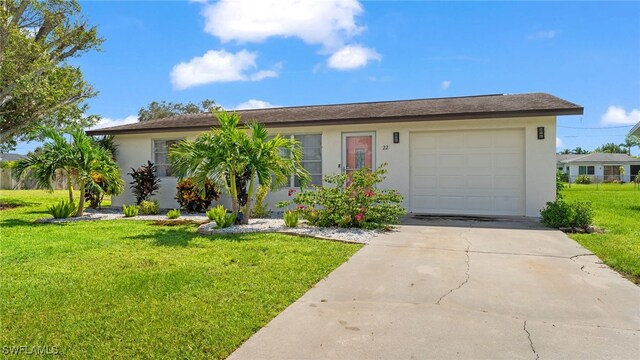 ranch-style house featuring a front yard and a garage