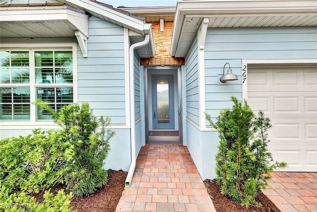 doorway to property with a garage