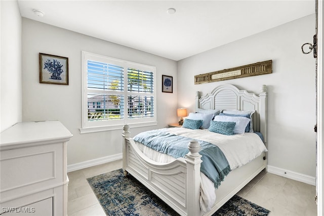 bedroom with light tile patterned floors