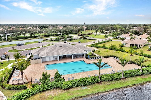 view of swimming pool with a patio area and a water view