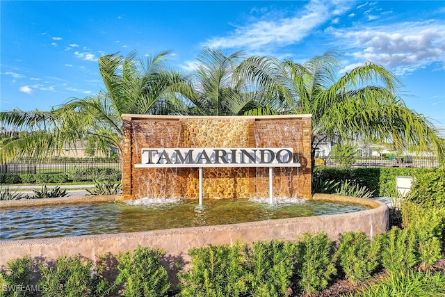 community / neighborhood sign with a water view