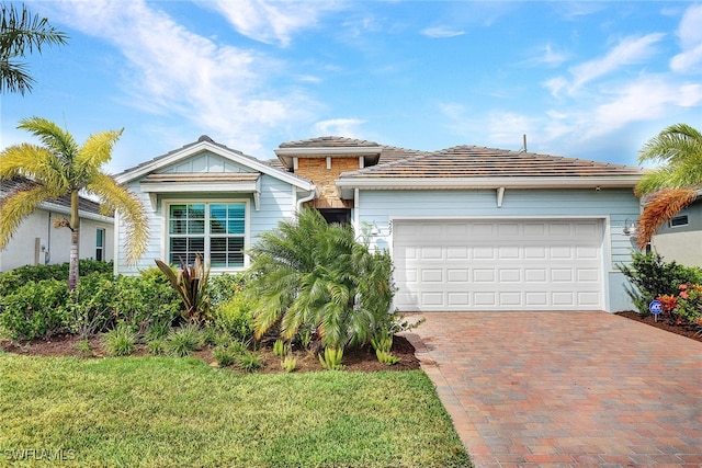 view of front facade with a front yard and a garage