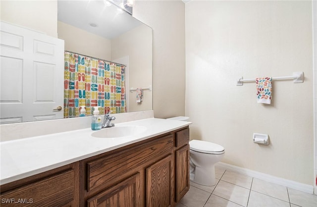 bathroom featuring tile patterned flooring, vanity, and toilet