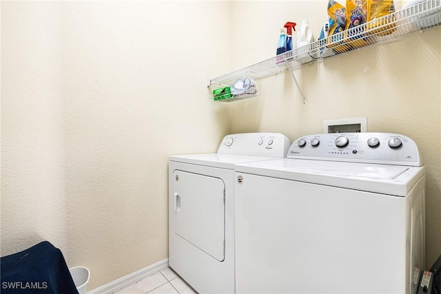 washroom with independent washer and dryer and light tile patterned floors