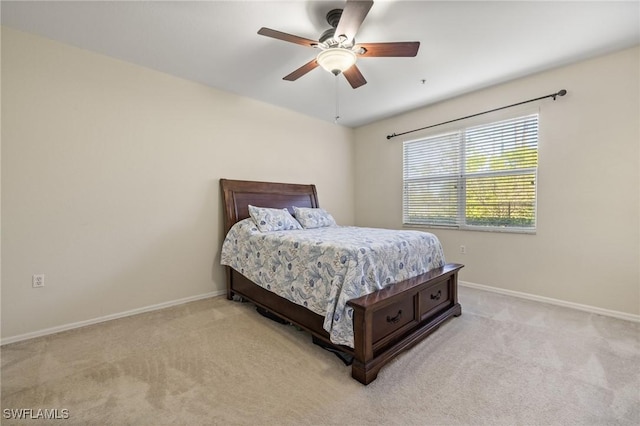 bedroom featuring ceiling fan and light carpet